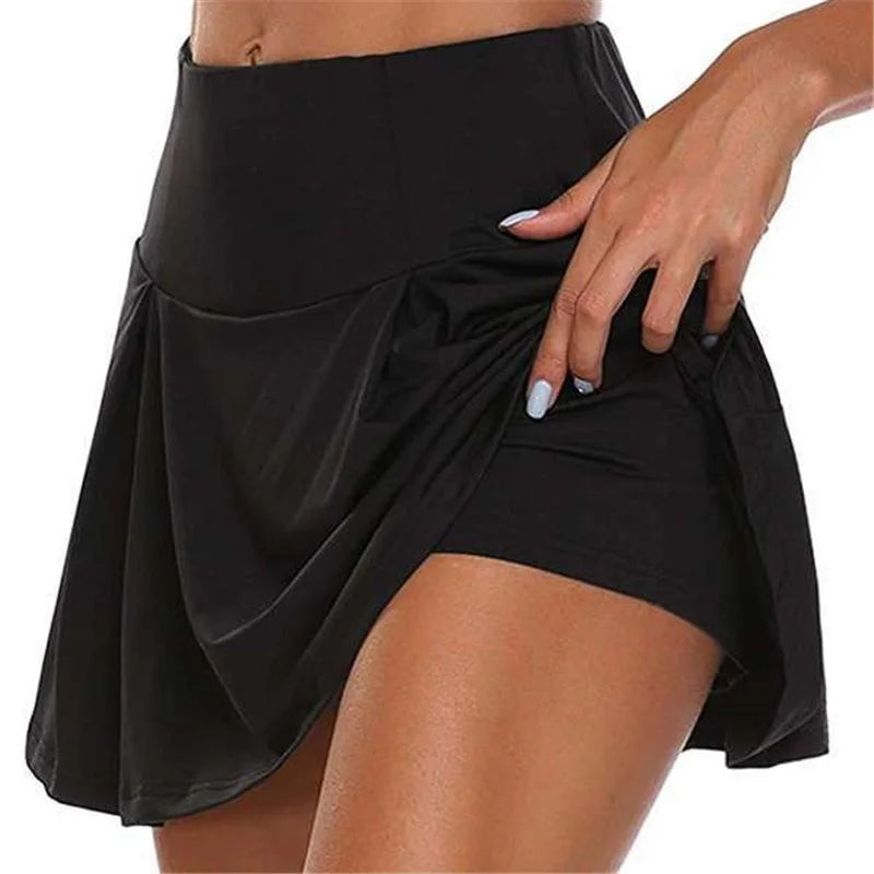 Minifalda de cintura alta con shorts integrados y tejido de secado rápido. Ideal para tenis, fitness, baile y actividades deportivas, combinando comodidad, estilo y libertad de movimiento.