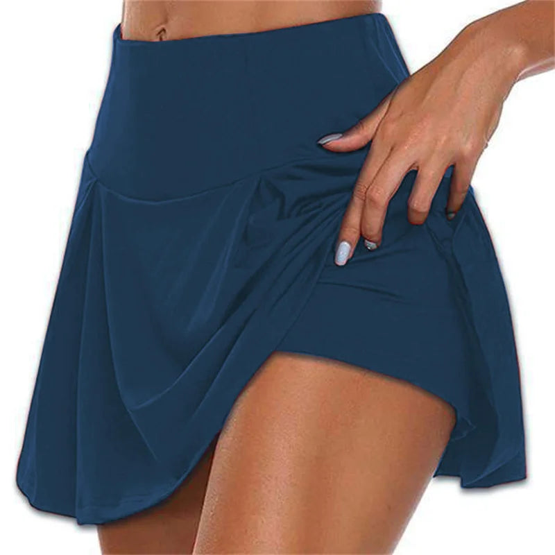Minifalda de cintura alta con shorts integrados y tejido de secado rápido. Ideal para tenis, fitness, baile y actividades deportivas, combinando comodidad, estilo y libertad de movimiento.